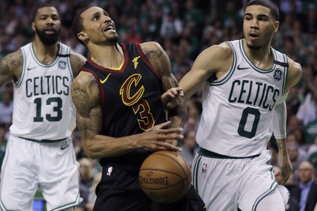 Cleveland Cavaliers guard George Hill (3) loses control of the ball against Boston Celtics forward Jayson Tatum (0) as Celtics forward Marcus Morris (13) watches, left, during the second quarter of Game 5 of the NBA basketball Eastern Conference Finals, Wednesday, May 23, 2018, in Boston. (AP Photo/Charles Krupa)