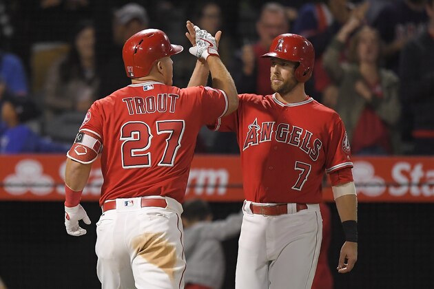 Los Angeles Angels' Mike Trout, left, is congratulated by Zack Cozart after hitting a two-run home run during the ninth inning of a baseball game against the Tampa Bay Rays on Saturday, May 19, 2018, in Anaheim, Calif. (AP Photo/Mark J. Terrill)