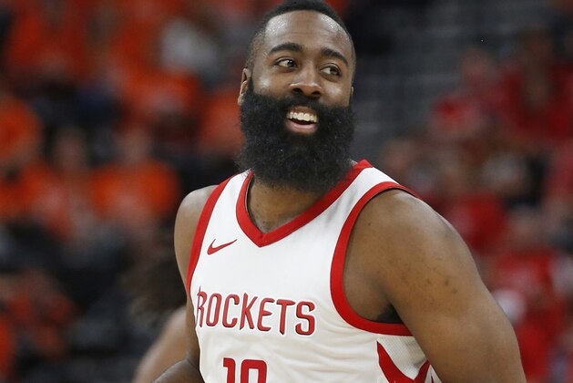 Houston Rockets guard James Harden smiles as he runs up the court after scoring a 3-pointer against the Utah Jazz during the second half in Game 3 of an NBA basketball second-round playoff series Friday, May 4, 2018, in Salt Lake City. The Rockets won 113-92. (AP Photo/Rick Bowmer)