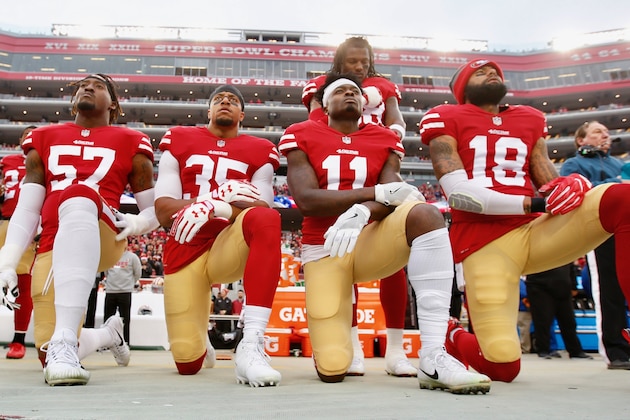 ORCHARD PARK, NY - OCTOBER 15: Eli Harold #58, Colin Kaepernick #7 and Eric Reid #35 of the San Francisco 49ers kneel in protest on the sideline, during the anthem,  prior to the game against the Buffalo Bills at New Era Field on October 16, 2016 in Orchard Park, New York. The Bills defeated the 49ers 45-16. (Photo by Michael Zagaris/San Francisco 49ers/Getty Images)