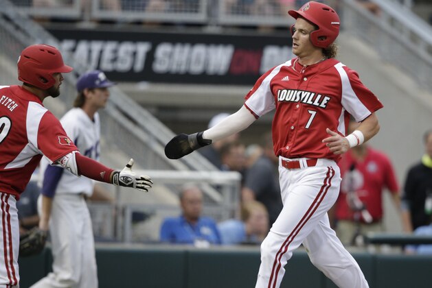 Louisville's Devin Mann (7) is congratulated by Colby Fitch, left, after he scored during the third inning of the team's NCAA College World Series baseball game against TCU in Omaha, Neb., Thursday, June 22, 2017. (AP Photo/Nati Harnik)