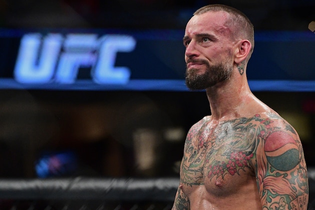 CM Punk stands in the octagon after being defeated by Mickey Gall during a welterweight bout at UFC 203 on Saturday, Sept. 10, 2016, in Cleveland.  (AP Photo/David Dermer)
