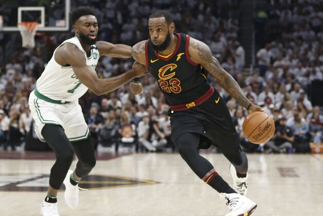 Cleveland Cavaliers' LeBron James (23) drives past Boston Celtics' Jaylen Brown (7) during the first half of Game 6 of the NBA basketball Eastern Conference finals Friday, May 25, 2018, in Cleveland. (AP Photo/Ron Schwane)