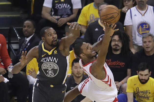 Houston Rockets forward Trevor Ariza, right, shoots against Golden State Warriors forward Kevin Durant (35) during the first half of Game 4 of the NBA basketball Western Conference Finals in Oakland, Calif., Tuesday, May 22, 2018. (AP Photo/Jeff Chiu)