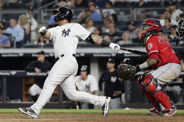 Los Angeles Angels catcher Martin Maldonado watches as New York Yankees' Gleyber Torres, left, follows through on a home run during the seventh inning of a baseball game Friday, May 25, 2018, in New York. (AP Photo/Frank Franklin II)