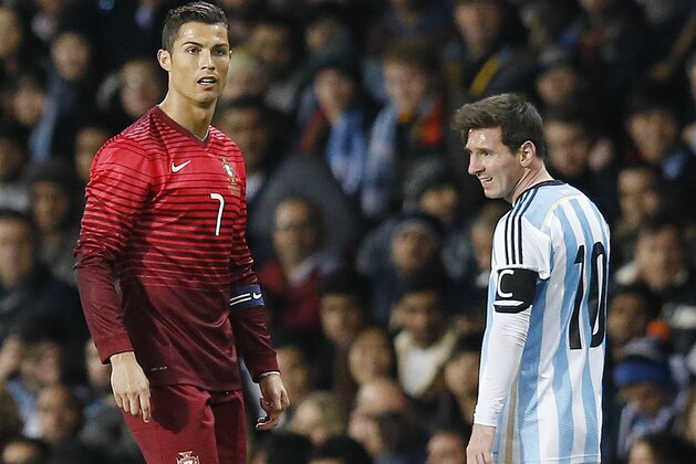 FILE - In this file photo dated Tuesday Nov. 18, 2014, Cristiano Ronaldo of Portugal, left, and Lionel Messi of Argentina, during their International Friendly soccer match at Old Trafford Stadium, Manchester, England. More worldwide soccer tournaments involving even more national teams could be coming to every odd-numbered year from 2021, according to officials of the UEFA-led Global Nations League project, Friday Nov. 3, 2017, which may replace the Confederation Cup, so the worlds best players may face off against each other at last.   (AP Photo/Jon Super, FILE)