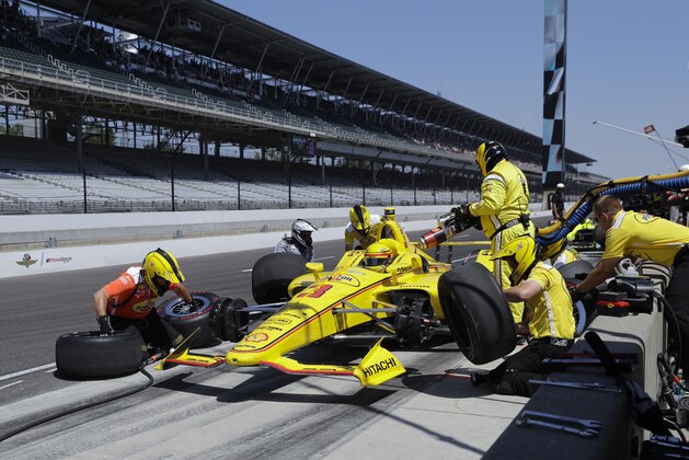 The crew of Helio Castroneves, of Brazil, practices a pit stop during the final practice session for the IndyCar Indianapolis 500 auto race at Indianapolis Motor Speedway, in Indianapolis Friday, May 25, 2018. (AP Photo/Darron Cummings)