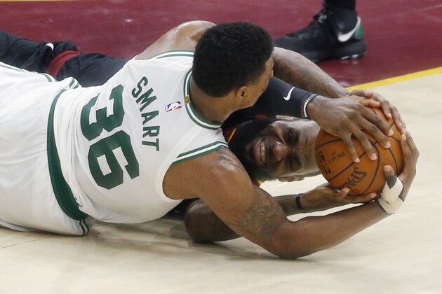 Cleveland Cavaliers' LeBron James, rear, and Boston Celtics' Marcus Smart battle for the ball during the second half of Game 6 of the NBA basketball Eastern Conference finals  Friday, May 25, 2018, in Cleveland. The Cavaliers won 109-99. (AP Photo/Ron Schwane)