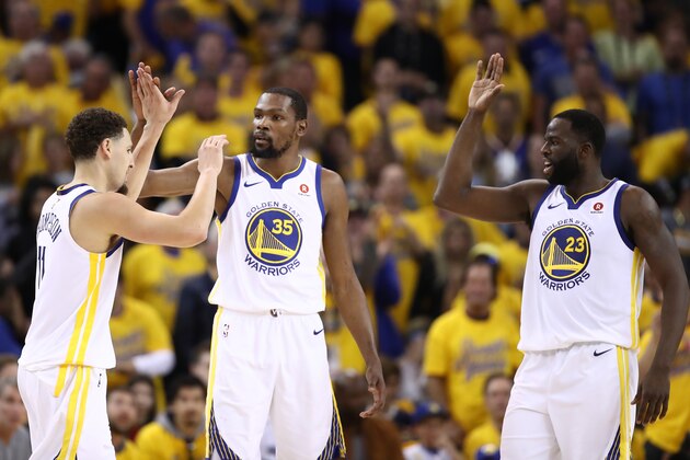 OAKLAND, CA - MAY 26:  Klay Thompson #11, Kevin Durant #35 and Draymond Green #23 of the Golden State Warriors celebrate after a play against the Houston Rockets during Game Six of the Western Conference Finals in the 2018 NBA Playoffs at ORACLE Arena on May 26, 2018 in Oakland, California. NOTE TO USER: User expressly acknowledges and agrees that, by downloading and or using this photograph, User is consenting to the terms and conditions of the Getty Images License Agreement.  (Photo by Ezra Shaw/Getty Images)