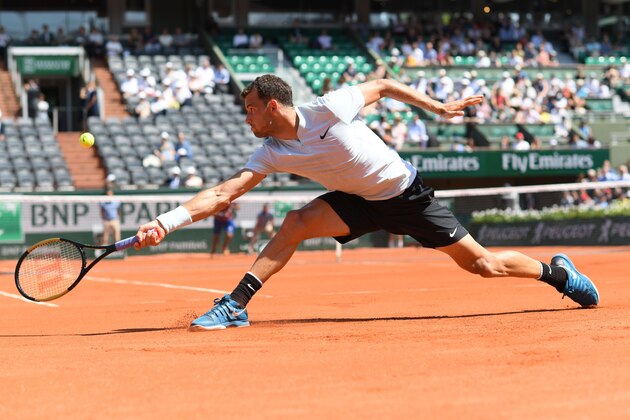 Bulgaria's Grigor Dimitrov plays a return to Egypt's Mohamed Safwat during their men's singles first round match on day one of The Roland Garros 2018 French Open tennis tournament in Paris on May 27, 2018. (Photo by CHRISTOPHE ARCHAMBAULT / AFP)        (Photo credit should read CHRISTOPHE ARCHAMBAULT/AFP/Getty Images)