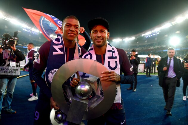 PARIS, FRANCE - MAY 12: (L-R) Kylian Mbappe of Paris Saint Germain, Neymar Jr of Paris Saint Germain celebrates the championship with the trophy  during the French League 1  match between Paris Saint Germain v Rennes at the Parc des Princes on May 12, 2018 in Paris France (Photo by Jean Marie Hervio/Soccrates/Getty Images)