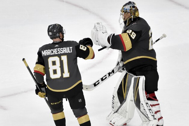 Vegas Golden Knights center Jonathan Marchessault, left, celebrates with goaltender Marc-Andre Fleury after the teams 4-2 win against the Winnipeg Jets during Game 3 of the NHL hockey playoffs Western Conference finals Wednesday, May 16, 2018, in Las Vegas. (AP Photo/David Becker)