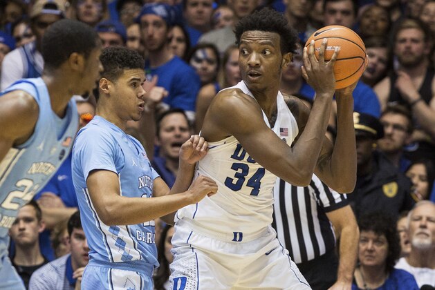 Duke's Wendell Carter Jr. (34) handles the ball in the post as North Carolina's Cameron Johnson (13) defends during the second half of an NCAA college basketball game in Durham, N.C., Saturday, March 3, 2018. Duke defeated North Carolina 74-64. (AP Photo/Ben McKeown)