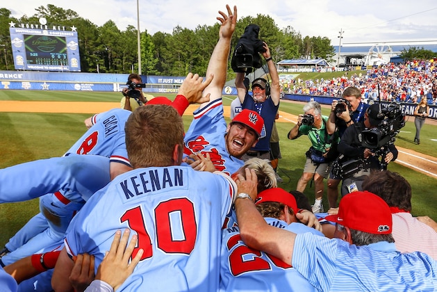 Mississippi players pile up in celebration after defeating LSU in the Southeastern Conference tournament NCAA college baseball championship game, Sunday, May 27, 2018, in Hoover, Ala. (AP Photo/Butch Dill)