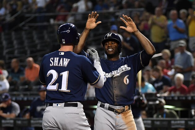 PHOENIX, AZ - MAY 16:  Travis Shaw #21 of the Milwaukee Brewers celebrates with teammate Lorenzo Cain #6 after hitting a two run home run against the Arizona Diamondbacks during the first inning at Chase Field on May 16, 2018 in Phoenix, Arizona.  (Photo by Norm Hall/Getty Images)