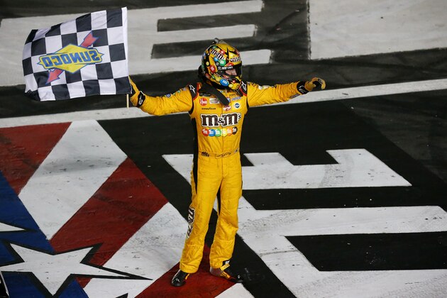 CHARLOTTE, NC - MAY 27:  Kyle Busch, driver of the #18 M&M's Red White & Blue Toyota, celebrates with the checkered flag after winning the Monster Energy NASCAR Cup Series Coca-Cola 600 at Charlotte Motor Speedway on May 27, 2018 in Charlotte, North Carolina.  (Photo by Sarah Crabill/Getty Images)