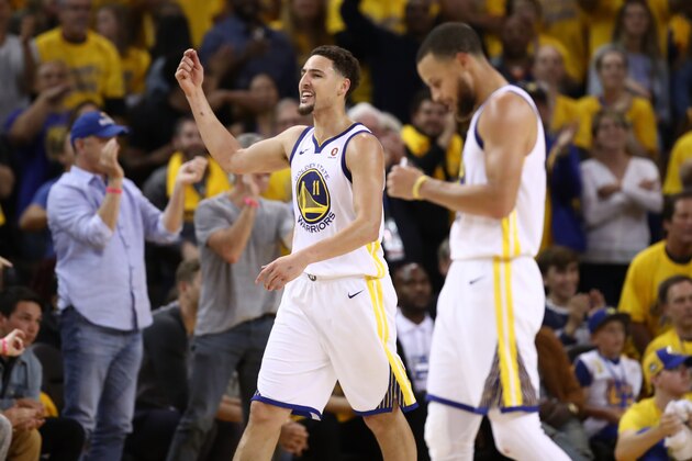 OAKLAND, CA - MAY 26:  Klay Thompson #11 of the Golden State Warriors reacts after scoring against the Houston Rockets during Game Six of the Western Conference Finals in the 2018 NBA Playoffs at ORACLE Arena on May 26, 2018 in Oakland, California. NOTE TO USER: User expressly acknowledges and agrees that, by downloading and or using this photograph, User is consenting to the terms and conditions of the Getty Images License Agreement.  (Photo by Ezra Shaw/Getty Images)