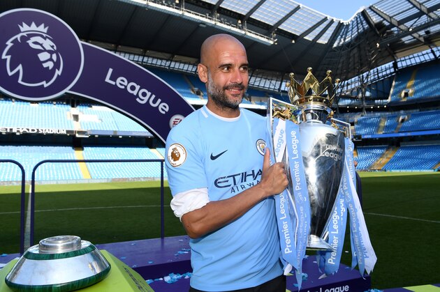MANCHESTER, ENGLAND - MAY 06:  Josep Guardiola, Manager of Manchester City poses with The Premier League Trophy after the Premier League match between Manchester City and Huddersfield Town at Etihad Stadium on May 6, 2018 in Manchester, England.  (Photo by Michael Regan/Getty Images)