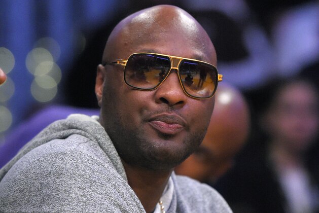 Former Los Angeles Laker Lamar Odom watches during the first half of an NBA basketball game between the Lakers and the Miami Heat, Wednesday, March 30, 2016, in Los Angeles. (AP Photo/Mark J. Terrill)