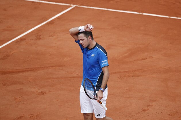 Switzerland's Stan Wawrinka wipes the sweat off his face in his first round match against Spain's Guillermo Garcia-Lopez at the French Open tennis tournament at the Roland Garros stadium in Paris, France, Monday, May 28, 2018. Wawrinka lost in five sets 6-2, 3-6, 4-6, 7-6 (7-5), 6-3. (AP Photo/Christophe Ena)