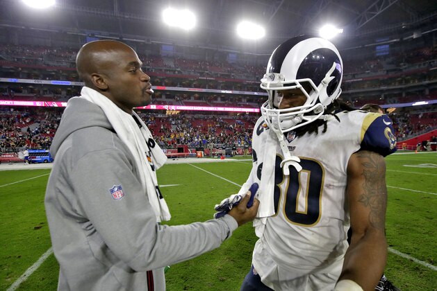 Arizona Cardinals running back Adrian Peterson, left, greets Los Angeles Rams running back Todd Gurley an NFL football game, Sunday, Dec. 3, 2017, in Glendale, Ariz. The Rams won 32-16. (AP Photo/Rick Scuteri)