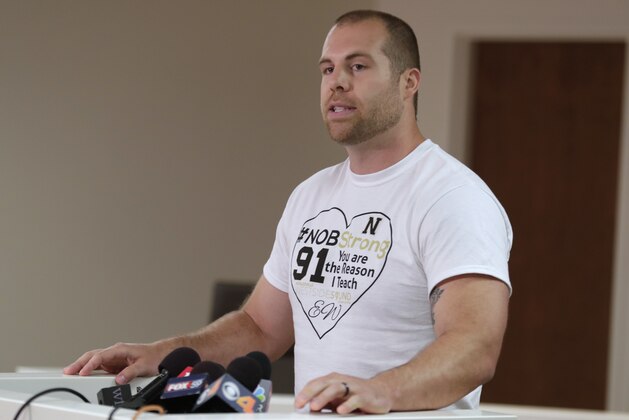 Jason Seaman, a seventh grade science teacher at Noblesville West Middle School in Noblesville, Ind., speaks during a news conference Monday, May 28, 2018. Seaman tackled and disarmed a student with a gun at the school on Friday. He was shot but not seriously injured. (AP Photo/Michael Conroy)