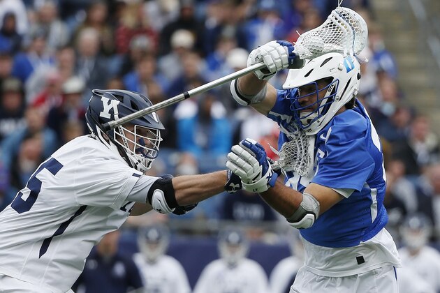Yale's Jason Alessi, left, defends against Duke's Brad Smith during the first half of an NCAA college Division I championship final lacrosse game, Monday, May 28, 2018, in Foxborough, Mass. (AP Photo/Michael Dwyer)
