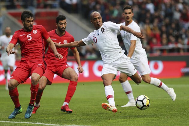 Portugal's Joao Mario, 2nd right, attempts a shot at goal during a friendly soccer match between Portugal and Tunisia in Braga, Portugal, Monday, May 28, 2018. (AP Photo/Armando Franca)