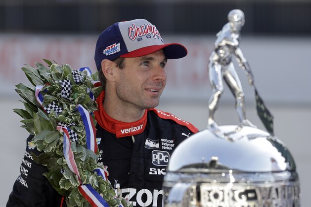 Indianapolis 500 champion Will Power, of Australia, poses with the Borg-Warner Trophy during the traditional winners photo session on the start/finish line at the Indianapolis Motor Speedway, Monday, May 28, 2018, in Indianapolis. (AP Photo/Darron Cummings)