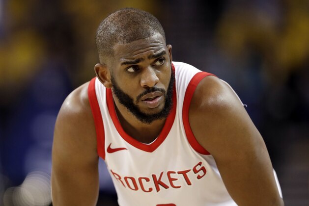 FILE - In this Tuesday, May 22, 2018, file photo, Houston Rockets' Chris Paul watches during the second half in Game 4 of the NBA basketball Western Conference Finals against the Golden State Warriors in Oakland, Calif. The Rockets will be without star guard Chris Paul for Game 6 because of a strained hamstring, a huge blow for a team trying to close out the Warriors. (AP Photo/Marcio Jose Sanchez, File)