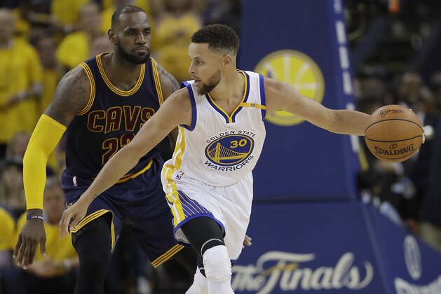 Golden State Warriors guard Stephen Curry (30) is guarded by Cleveland Cavaliers forward LeBron James during the second half of Game 1 of basketball's NBA Finals in Oakland, Calif., Thursday, June 1, 2017. (AP Photo/Marcio Jose Sanchez)