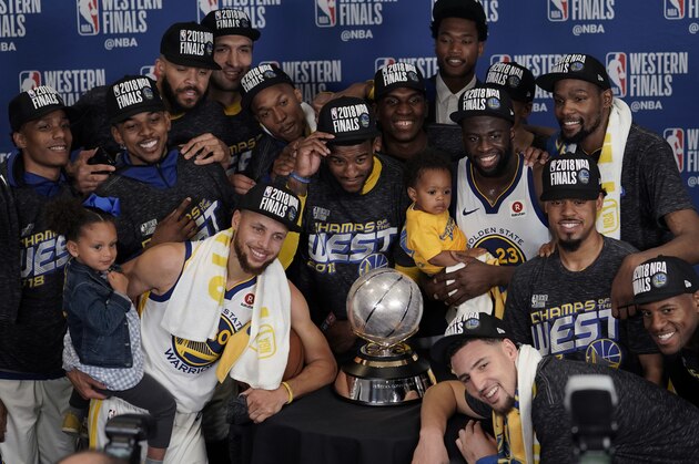 The Golden State Warriors pose with their trophy after defeating the Houston Rockets in Game 7 of the NBA basketball Western Conference finals, Monday, May 28, 2018, in Houston. (AP Photo/David J. Phillip)