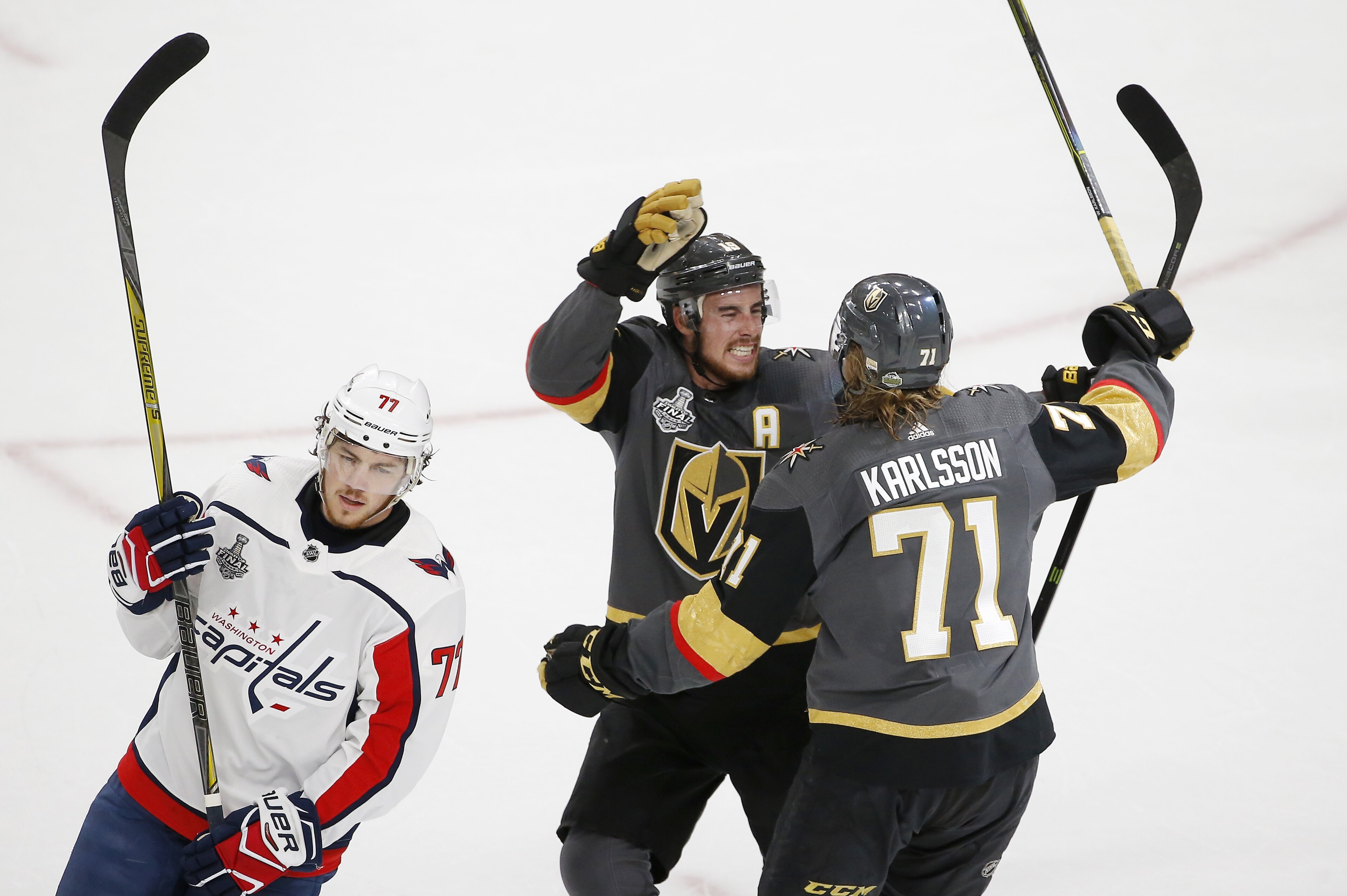 Vegas Golden Knights center William Karlsson, right, of Sweden, celebrates his goal with left wing James Neal, center, as Washington Capitals right wing T.J. Oshie skates away during first period in Game 1 of the NHL hockey Stanley Cup Finals Monday, May 28, 2018, in Las Vegas. (AP Photo/Ross D. Franklin)