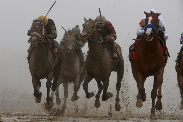 BALTIMORE, MD - MAY 19: Justify  #7 ridden by jockey Mike Smith (R) crosses the finish line to win the 143rd running of the Preakness Stakes at Pimlico Race Course on May 19, 2018 in Baltimore, Maryland. (Photo by Rob Carr/Getty Images)