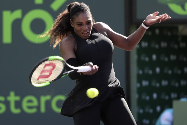 In this photo taken on Wednesday, March 21, 2018, Serena Williams returns to Naomi Osaka of Japan, during the Miami Open tennis tournament, in Key Biscayne, Fla. Serena Williams' coach says she will play the French Open beginning in two weeks. The tournament will mark the 23-time Grand Slam champion's first major since returning to the tour from maternity leave. Coach Patrick Mouratoglou tells the WTA tour's website,