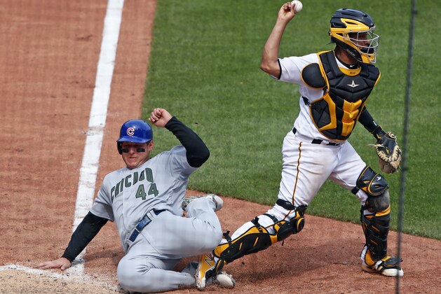 Pittsburgh Pirates catcher Elias Diaz throws to first after getting the force out at home plate on Chicago Cubs' Anthony Rizzo (44) on a fielder's choice to shortstop by Cub's Chris Gimenez in the eighth inning of a baseball game in Pittsburgh, Monday, May 28, 2018. Diaz's errant throw to first allowed two runs to score. (AP Photo/Gene J. Puskar)