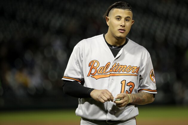 Baltimore Orioles' Manny Machado waits for his cap and glove after making the last out in the top half of the fifth inning of a baseball game against the Chicago White Sox Tuesday, May 22, 2018, in Chicago. (AP Photo/Charles Rex Arbogast)