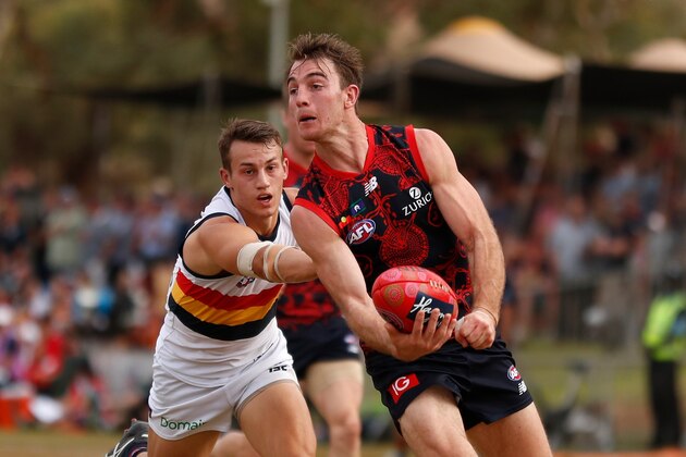 ALICE SPRINGS, AUSTRALIA - MAY 27: Tim Smith of the Demons is tackled by Tom Doedee of the Crows during the 2018 AFL round 10 match between the Melbourne Demons and the Adelaide Crows at TIO Traeger Park on May 27, 2018 in Alice Springs, Australia. (Photo by Michael Willson/AFL Media/Getty Images)