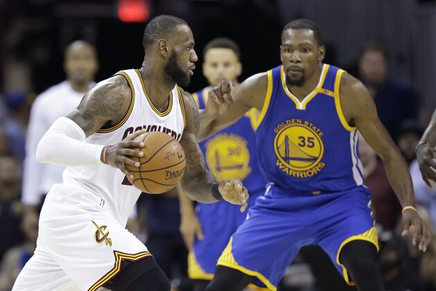 FILE - In this June 9, 2017 file photo, Cleveland Cavaliers forward LeBron James (23) drives on Golden State Warriors forward Kevin Durant (35) during the second half of Game 4 of basketball's NBA Finals in Cleveland. The NBA is driven by star power and its Christmas Day lineup is about the league’s best players, not all the best teams. Yes, the NBA will roll out LeBron James and Kevin Durant, toss in some Russell Westbrook and James Harden under the mistletoe. (AP Photo/Tony Dejak, File)