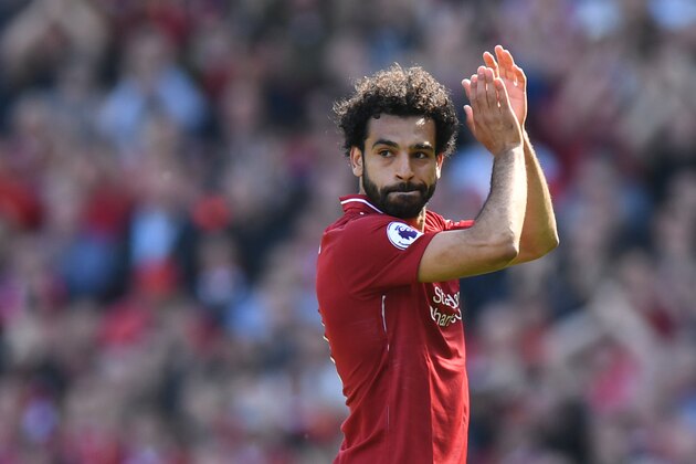Liverpool's Egyptian midfielder Mohamed Salah applauds fans as he is substituted during the English Premier League football match between Liverpool and Brighton and Hove Albion at Anfield in Liverpool, north west England on May 13, 2018. (Photo by Paul ELLIS / AFP) / RESTRICTED TO EDITORIAL USE. No use with unauthorized audio, video, data, fixture lists, club/league logos or 'live' services. Online in-match use limited to 75 images, no video emulation. No use in betting, games or single club/league/player publications. /         (Photo credit should read PAUL ELLIS/AFP/Getty Images)