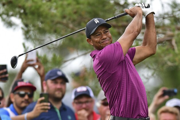 Tiger Woods follows through on his swing from the rough on the tenth hole during the pro-am for the the Memorial golf tournament Wednesday, May 30, 2018, in Dublin, Ohio. (AP Photo/David Dermer)