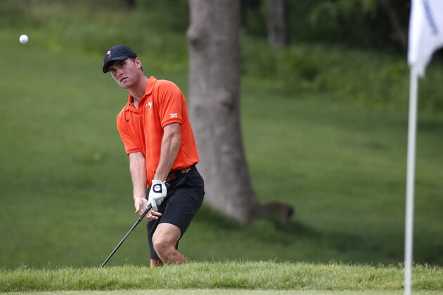 Oklahoma State's Austin Eckroat swings from the bunker on hole three during the final round of the NCAA Division I Men's Golf Championships in Stillwater, Okla., Wednesday, May 30, 2018. (AP Photo/Mitch Alcala)