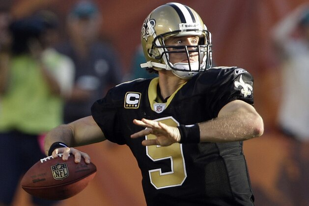 FILE - In this Oct. 25, 2009, file photo, New Orleans Saints quarterback Drew Brees (9) steps back to pass in the second quarter against the Miami Dolphins during an NFL football game in Miami. Perhaps the secret to NFL perfection is having a Purdue quarterback on your roster. Don't believe it? The Saints, Broncos and Colts are a combined 18-0 this season, the only unbeaten teams in the league. New Orleans has Drew Brees and Denver has Kyle Orton, while the backup in Indianapolis is former Boilermaker Curtis Painter.  (AP Photo/Lynne Sladky, File)