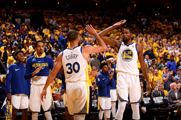 OAKLAND, CA - MAY 20:  Stephen Curry #30 and Kevin Durant #35 of the Golden State Warriors high five during the game against the Houston Rockets in Game Three of the Western Conference Finals of the 2018 NBA Playoffs on May 20, 2018 at ORACLE Arena in Oakland, California. NOTE TO USER: User expressly acknowledges and agrees that, by downloading and or using this photograph, user is consenting to the terms and conditions of Getty Images License Agreement. Mandatory Copyright Notice: Copyright 2018 NBAE (Photo by Noah Graham/NBAE via Getty Images)