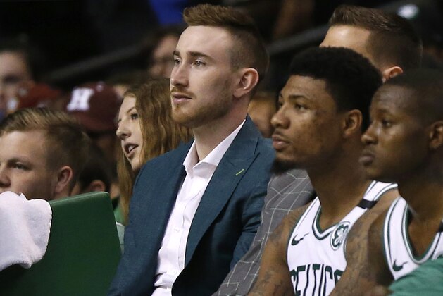 Injured Boston Celtics forward Gordon Hayward, left, watches from the bench with guards Marcus Smart, center, and Terry Rozier, right, in the fourth quarter during Game 1 of the NBA basketball Eastern Conference Finals against the Cleveland Cavaliers, Sunday, May 13, 2018, in Boston. (AP Photo/Michael Dwyer)