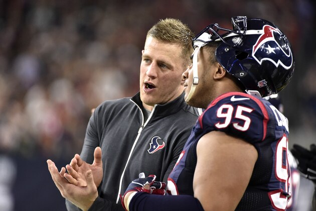 Houston Texans' J.J. Watt, left, talks with Christian Covington (95) during the second half of an NFL football game against the Cincinnati Bengals Saturday, Dec. 24, 2016, in Houston. (AP Photo/Eric Christian Smith)