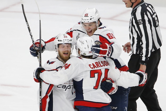 Washington Capitals center Lars Eller, left, celebrates his goal with defenseman John Carlson, center, and left wing Andre Burakovsky, of Austria, during the first period in Game 2 of the NHL hockey Stanley Cup Finals against the Vegas Golden Knights on Wednesday, May 30, 2018, in Las Vegas. (AP Photo/Ross D. Franklin)