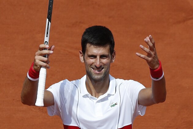 Serbia's Novak Djokovic celebrates winning his second round match of the French Open tennis tournament against Spain's Jaume Munar at the Roland Garros stadium in Paris, France, Wednesday, May 30, 2018. (AP Photo/Christophe Ena)