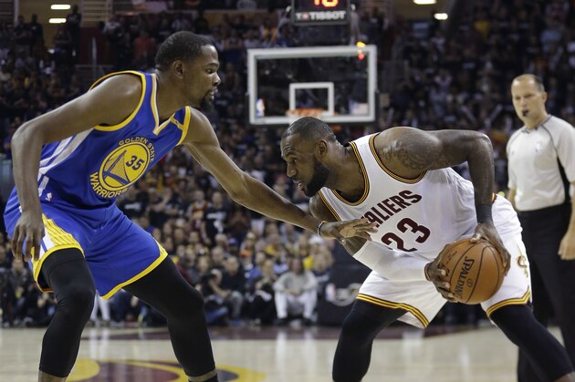 Golden State Warriors forward Kevin Durant (35) defends Cleveland Cavaliers forward LeBron James (23) diromg the first half of Game 4 of basketball's NBA Finals in Cleveland, Friday, June 9, 2017. (AP Photo/Tony Dejak)