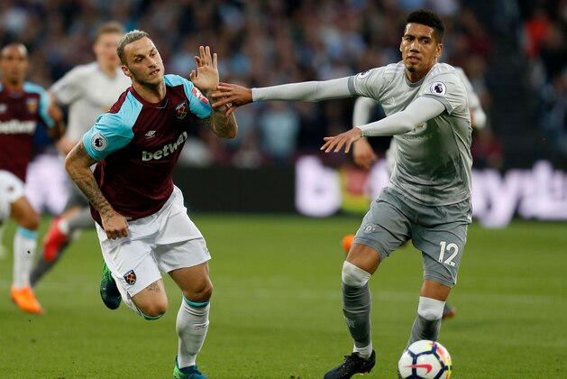 West Ham United's Austrian midfielder Marko Arnautovic (L) vies with Manchester United's English defender Chris Smalling during the English Premier League football match between West Ham United and Manchester United at The London Stadium, in east London on May 10, 2018. (Photo by Ian KINGTON / AFP) / RESTRICTED TO EDITORIAL USE. No use with unauthorized audio, video, data, fixture lists, club/league logos or 'live' services. Online in-match use limited to 75 images, no video emulation. No use in betting, games or single club/league/player publications. /         (Photo credit should read IAN KINGTON/AFP/Getty Images)